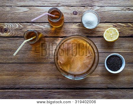 Kombucha By Fermenting Tea With Symbiotic Culture Of Bacteria And Yeast On Wooden Table.  Top View.