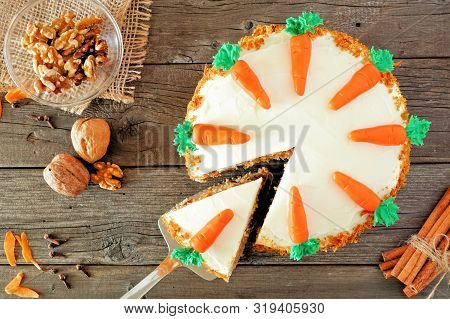 Homemade Carrot Cake With Cream Cheese Frosting. Top View Table Scene  With Slice Being Removed. Clo