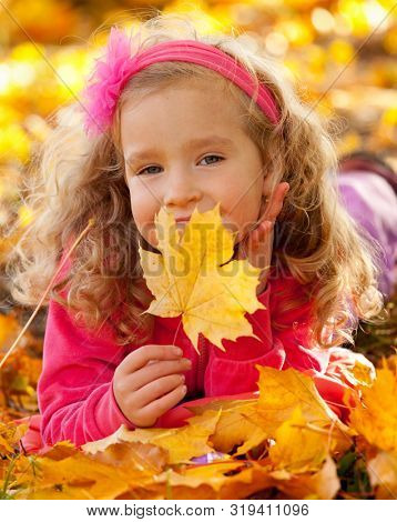 Happy little child in autumn park