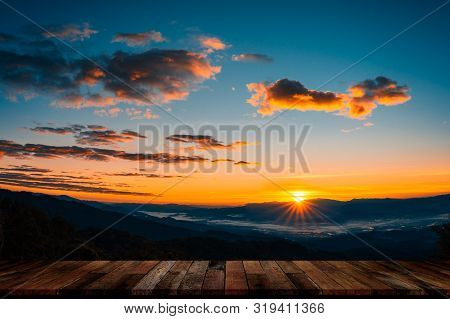 Empty Topp Of Wood Table With Beautiful Foggy Winter Sunrise In Mountains Background.