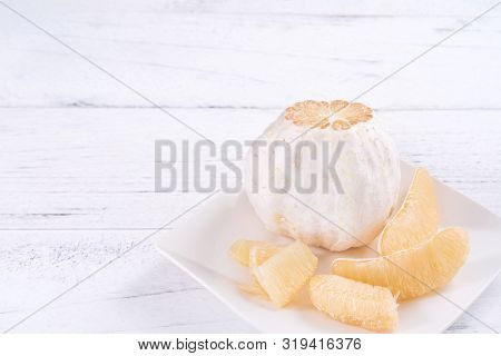 Fresh Peeled Pomelo, Grapefruit, Shaddock With Green Leaf On Bright Wooden Plank Table. Seasonal Fru