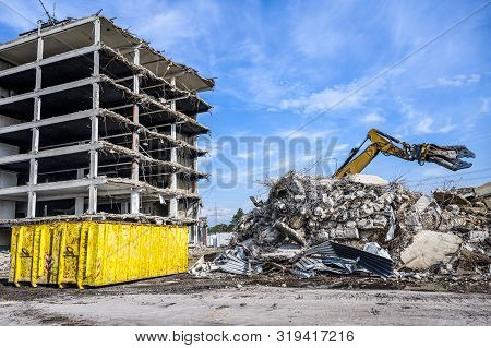 Building House Demolition Site Excavator With Hydraulic Crasher Machine And Yellow Container