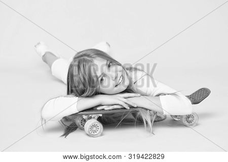 Spreading Happy Vibrations With The Penny Board. Small Girl Skater Relaxing At Penny Board Deck On P