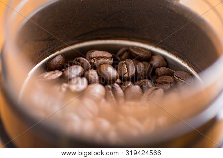 Coffee Beans Are Ground Into Coffee Powder By A Grinder