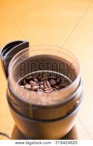 Coffee Beans Are Ground Into Coffee Powder By A Grinder