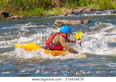 Myhiya, Ukraine - August 17, 2019: Playboating. A Man Sitting In A Kayak With Oars In His Hands Perf