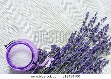 Lavender Flowers And Jar With Sea Salt On White Wooden Surfase. Spa Background With Copy Space. Sele