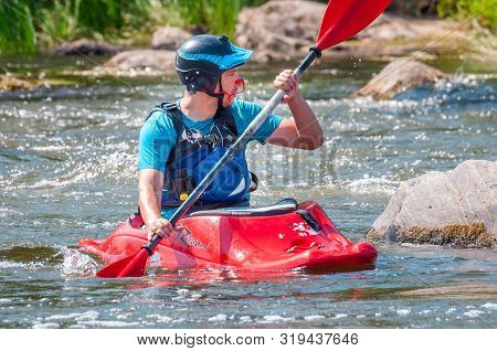 Myhiya, Ukraine - August 17, 2019: Playboating. A Man Sitting In A Kayak With Oars In His Hands Perf