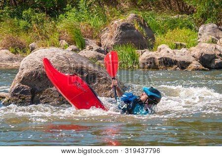 Myhiya, Ukraine - August 17, 2019: Playboating. A Man Sitting In A Kayak With Oars In His Hands Perf