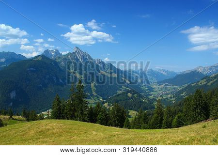 View From The Mountains Near Saanen, Switzerland, In Summer 2019. At The Right The Village Rougemont