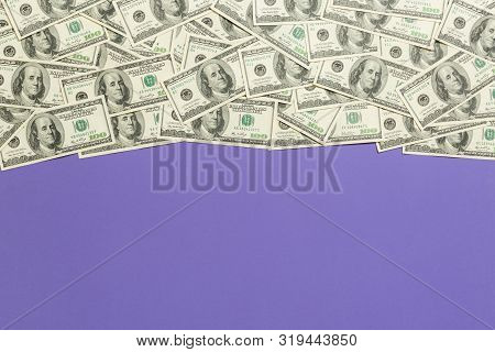 Top View Banknotes On Colored Desk With Copy Space On Top. One Hundred Dollar Bills With Stack Of Mo