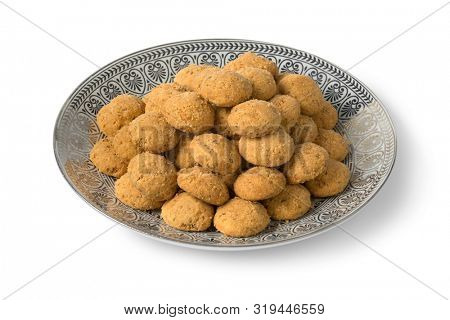 Dish with traditional homemade Moroccan festive ghoriba cookies isolated on white background