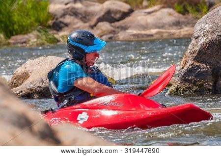 Myhiya, Ukraine - August 17, 2019: Playboating. A Man Sitting In A Kayak With Oars In His Hands Perf