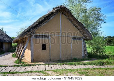 Historical Half-timbered House With Loam Plaster And  Thatched Roof In The Reconstructed Viking Vill