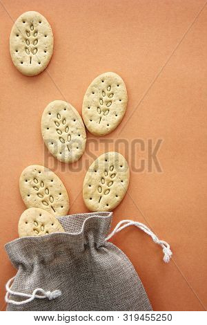 Reusable Canvas Bag And Multicereal Biscuits On Brown Background . Care For The Environment And Heal