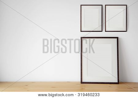 Blank Black Picture Frame On The White Wall And The Wooden Floor, Template Poster Interior Photo 3d 