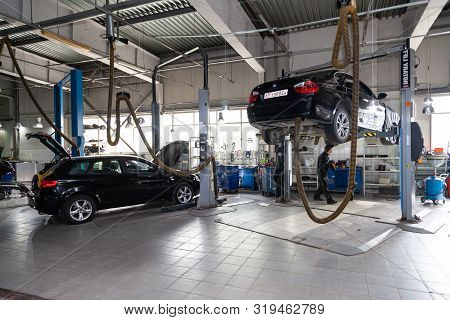 Novosibirsk, Russia - 08.01.2018: Two Used Cars With An Open Hood Raised On A Lift For Repairing The