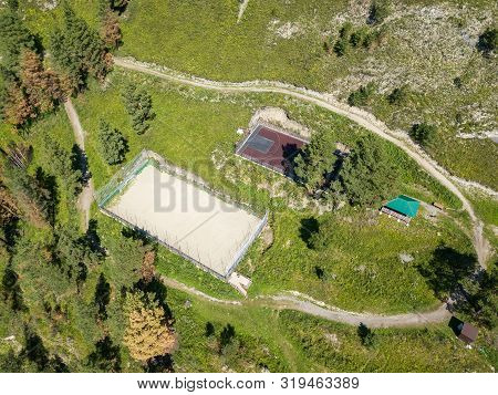 Aerial Vire On Two Sports Fields For Football And Basketball In The Altai Mountains Among Green Tree
