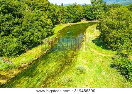 Beautiful River Gacka, Drone Aerial Over The River Surface Between The Trees, Lika Region Of Croatia