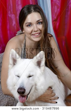 Young Attractive Caucasian Woman Embrases Expressive Dog Of Big Swiss Shepherd Breed. Beautiful Fema