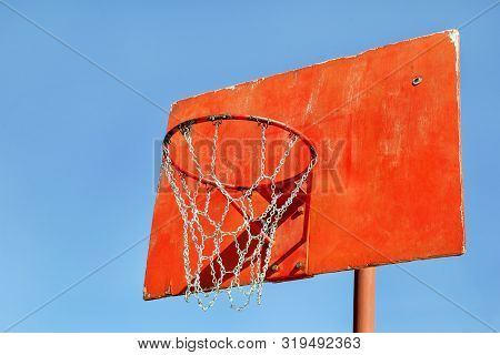 Closeup Of Red Basketball Hoop In Playground. Rusty Old Outdoor Basketball Red Board, Closeup. Baske