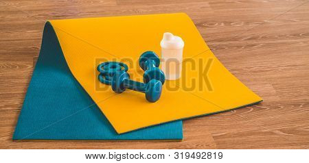 Water, Sports Blue Dumbbells At Karemat In The Gym. Sport Accessories. Sport Equipment Top View Back