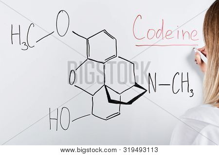 Cropped View Of Woman Writing Codeine On White Board