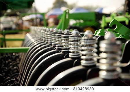 Spring Shock Absorbers Cultivator. A Fragment Of Agricultural Machinery For Loosening Plowed Fields.