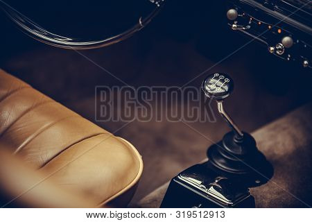 Close Up Vertical Shot Of The Gear Shifter Of A Vintage Car.