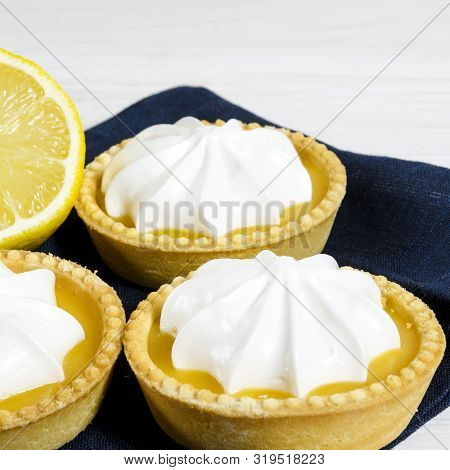 White Aircake With Lemon Filling And Lemon On A Wooden Table