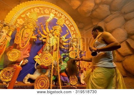 Kolkata, India - October 16, 2018 : Young Priest Praying To Goddess Durga Using Chamor - A Kind Of F
