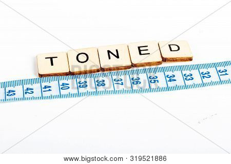 Health Concept Of A Tape Measure Also Showing The Message Toned