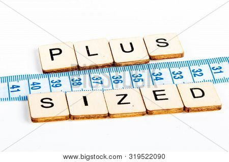 Health Concept Of A Tape Measure Also Showing The Message Plus Sized