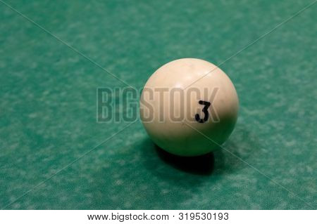 One White Billiard Balls On A Green Pool Table. Nomber 3.