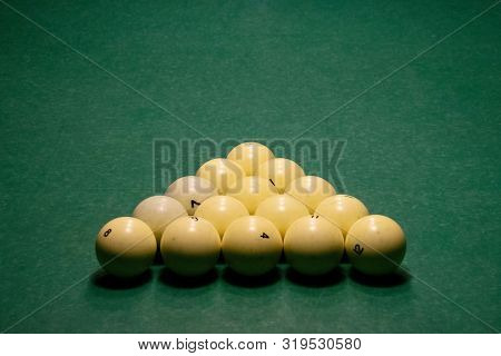 Ivory White Billiard Balls On A Blue Pool Table Close Up. Triangle Or Pyramid On The Table. There Is