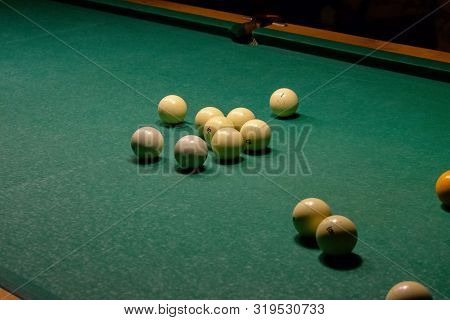 Ivory White Billiard Balls On A Green Pool Table. Triangle Or Pyramid On The Table.