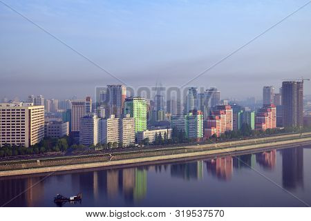 Pyongyang, North Korea - May 5, 2019: Skyline And Taedong River In The Morning Fog. View On Modern R