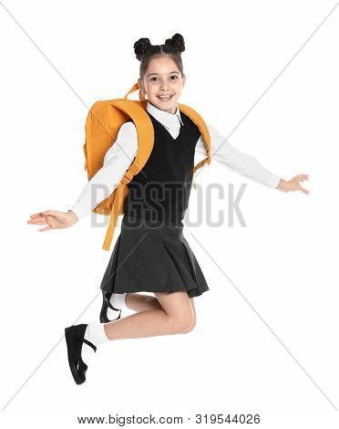 Happy Girl In School Uniform Jumping On White Background