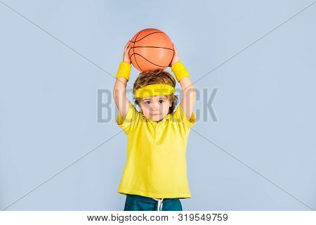 Small Boy In Sport Uniform Playing Basketball. Little Basketball Player In Sportswear Trows Ball. Sp