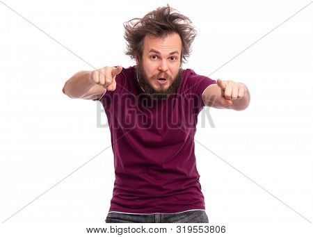 Portrait of handsome bearded man pointing fingers at camera, isolated on white background. Happy crazy smiling male points his fingers at you. Caucasian man with funny haircut looking at camera.