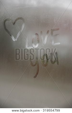 Beautiful Heart Symbol And Love You Word On The Glass Window With Water Drobs.