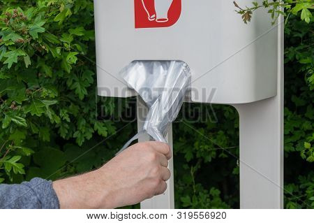 The Hand Of The Man Take Cellophane Gloves On The Gas Station.