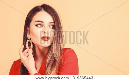 Fashion Trend. Jewelry Shop. Girl Model Long Hair Demonstrating Golden Jewelry Earrings. Expensive A