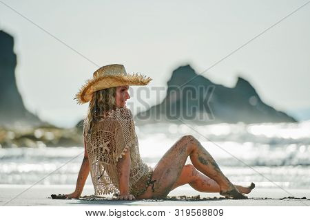 young woman relaxing on the beach in summer day