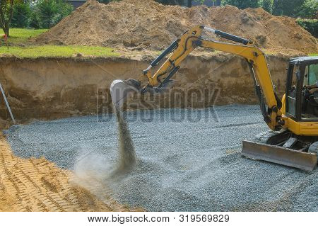 A Yellow Excavator Bucket Shovel Moving Gravel Stones Of Foundation On A Construction Site Stone Bac