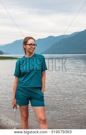 Woman on Teletskoye lake in Altai mountains, Siberia, Russia. Beauty summer day.