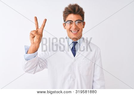Young handsome sciencist man wearing glasses and coat over isolated white background showing and pointing up with fingers number two while smiling confident and happy.