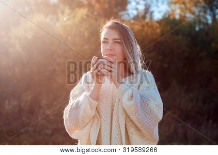 Beautiful Admiring Woman Drinking Hot Tea From Thermos Cup With Backligth Sun.