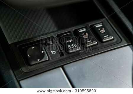 Close-up Of Black Of Seat Heating, Side Mirror, 4wd, 2wd, Lock Buttons On Car Panel, No Trade Marks