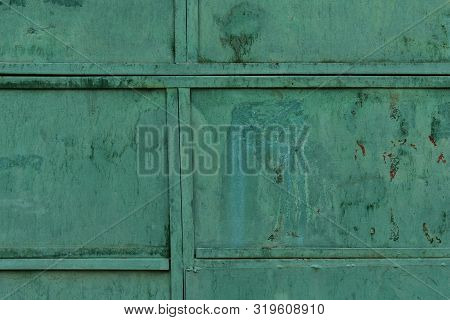 Green Metallic Texture. Old Iron Surface Background. Peeling Paint, Water Stains And Rust.